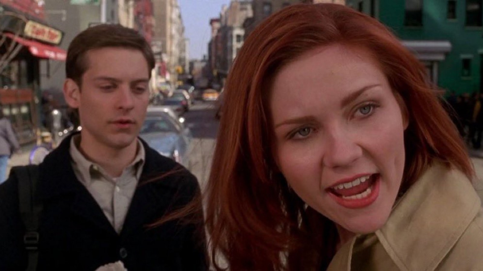 In Spiderman, Mary Jane stands next to Peter Parker in a still from the film.