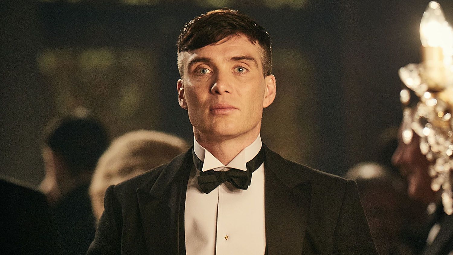 Cillian Murphy as Tommy Shelby in Peaky Blinders. He is dressed in a suit.