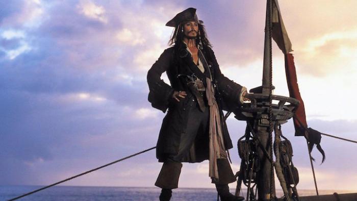 Johnny Depp as Jack Sparrow stands atop the mast