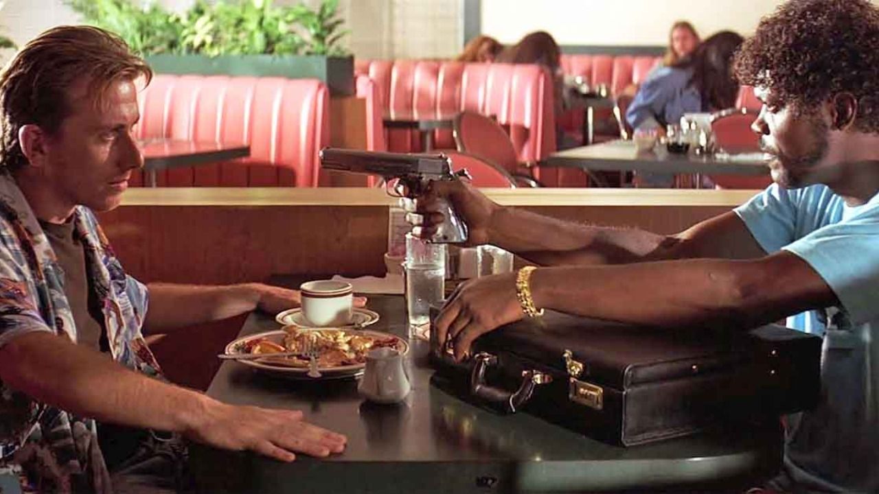 Samuel L. Jackson as Jules Winnfield pulling a gun in the diner scene in Pulp Fiction.