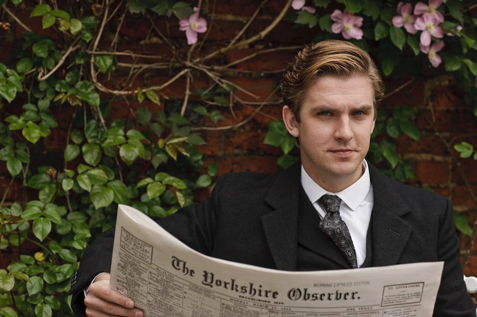 Dan Stevens, in character as Matthew Crawley reads a prop newspaper (The Yorkshire Observer)