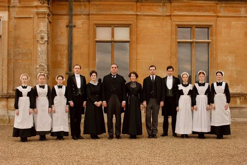 The servants of Downton Abbey line up outside to receive visitors.