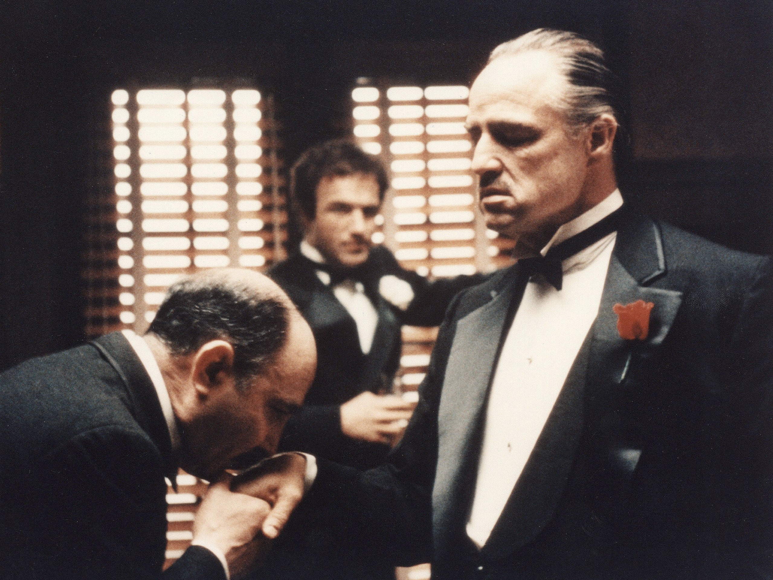 Vito Corelone as the head of the crime family as people in the community come to pay their respects to him