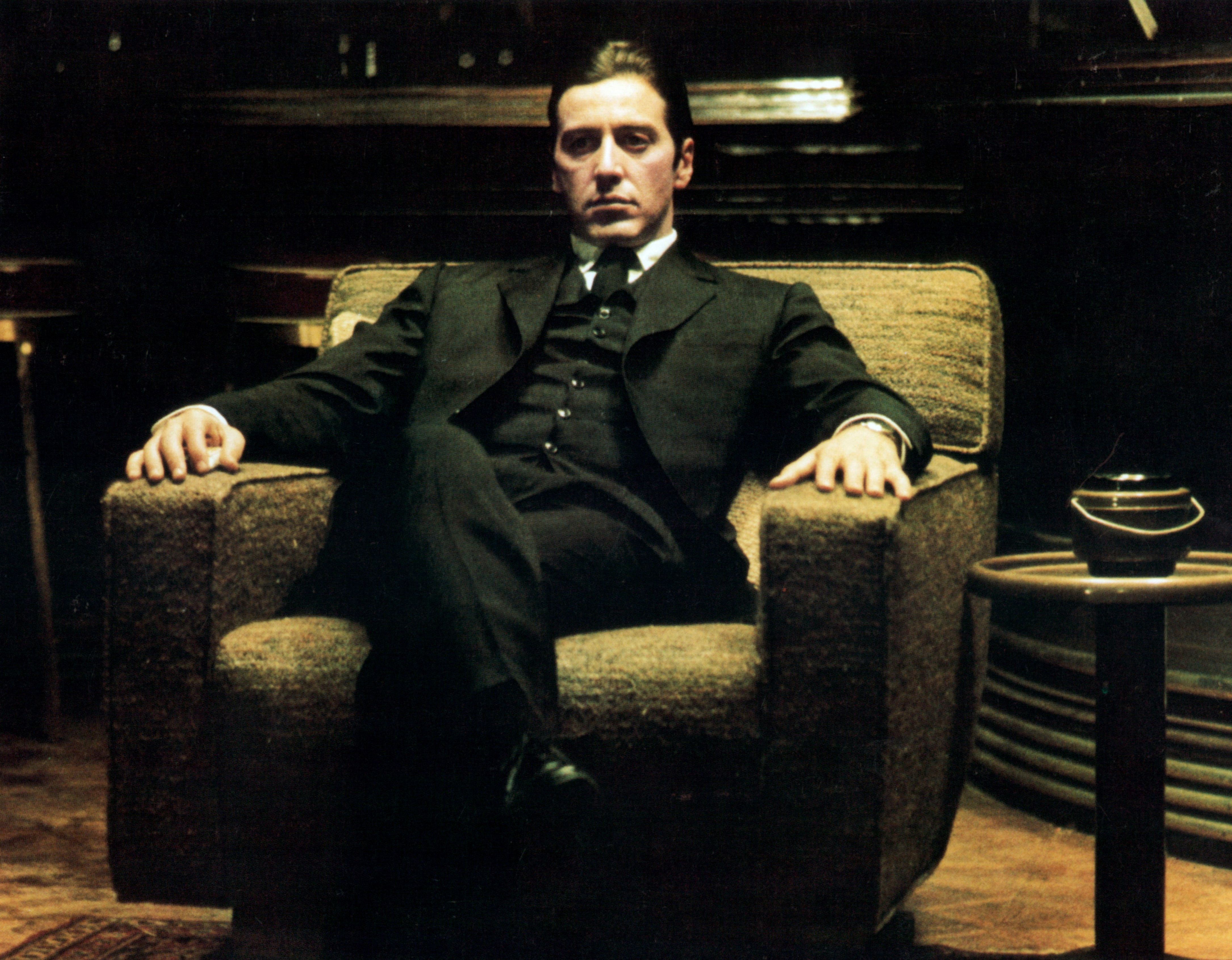 Michael Corleone in The Godfather sitting in his chair at the end of the film as the head of the crime family