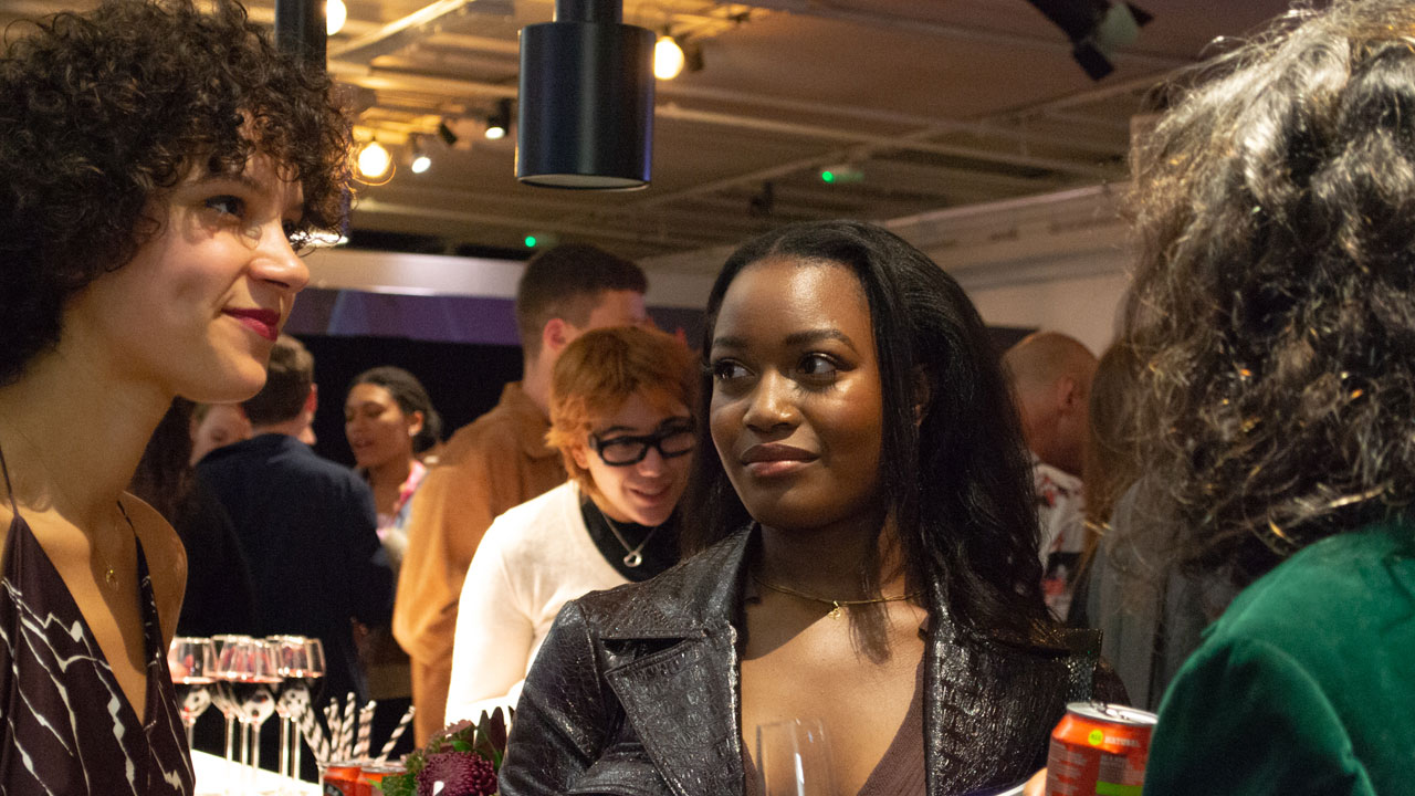 A group of writing attending networking drinks and clutching glasses at the BFI Future Film Festival 2022.
