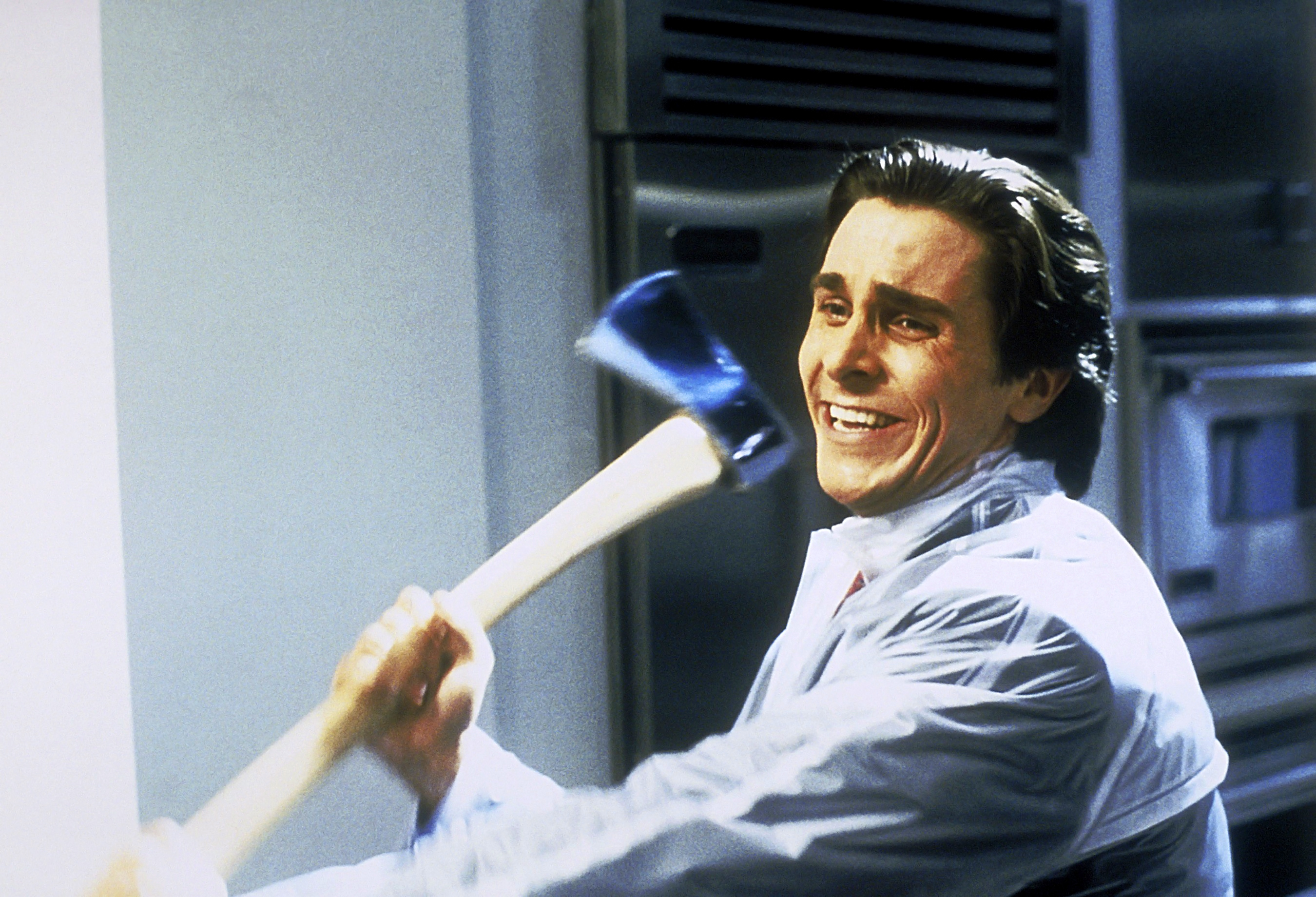 Patrick Bateman the serial killer lead in American Psycho carrying an axe, preparing to kill