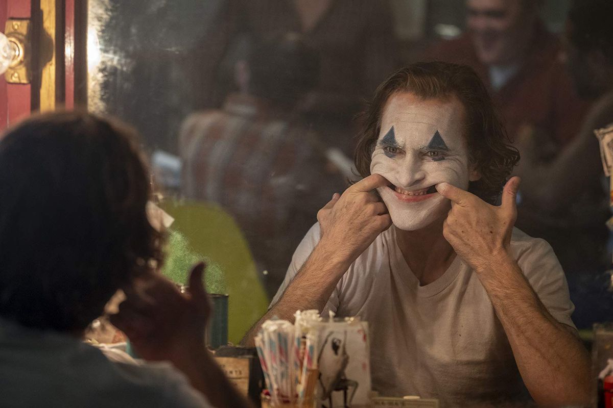 The Joker pulls his face into a smile.